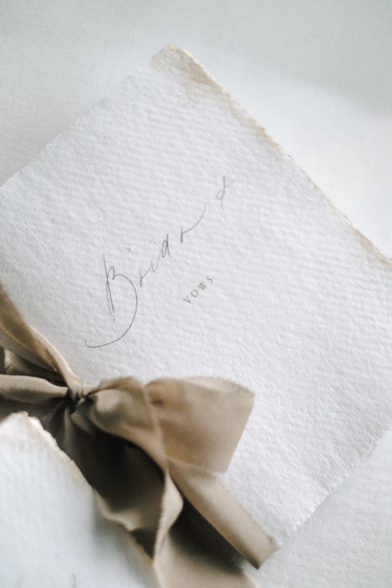 vow books with neutral beige silk ribbon